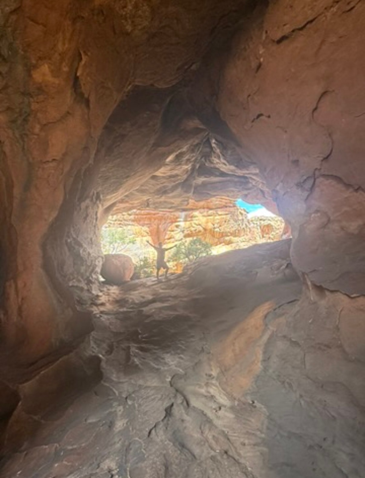 Cave opening overlooking desert landscape